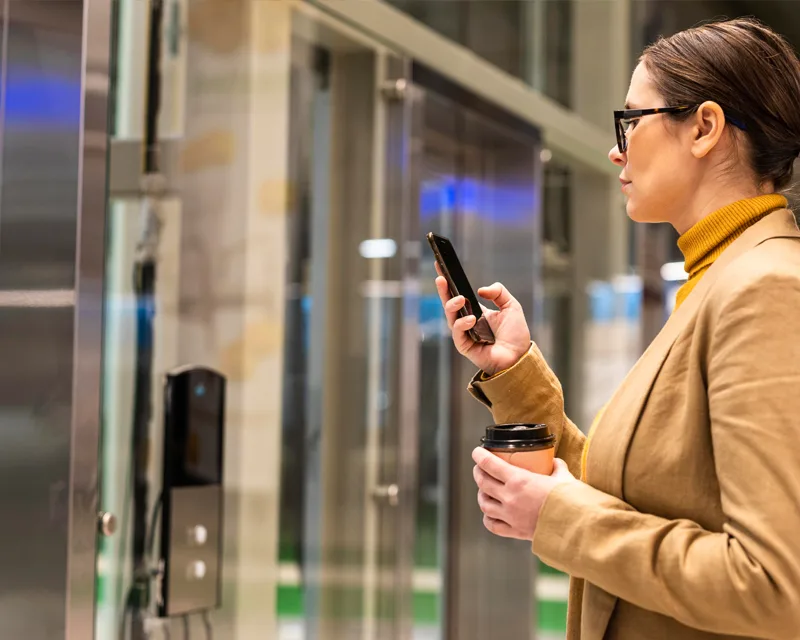 Lift Compliance - Women waiting for lift using phone